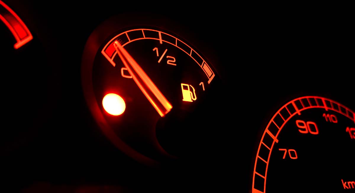 En bränslemätare i en bil visar på kritiskt låg nivå.